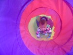 Akilah explores the tent tunnel (6 months)