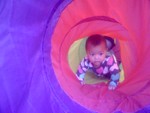 Akilah explores the tent tunnel (6 months)