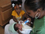 Lynda and Mia feeding Jaynce