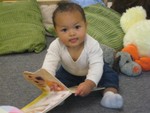 Nicholas playing with board books