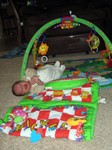 Nicholas rolling over and out of his playmat
