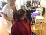 Marcy preparing Rashida's hair