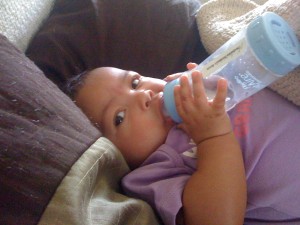 Akilah holding a bottle for her feeding